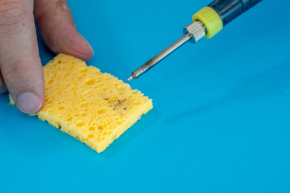 Cleaning the tip of the soldering iron